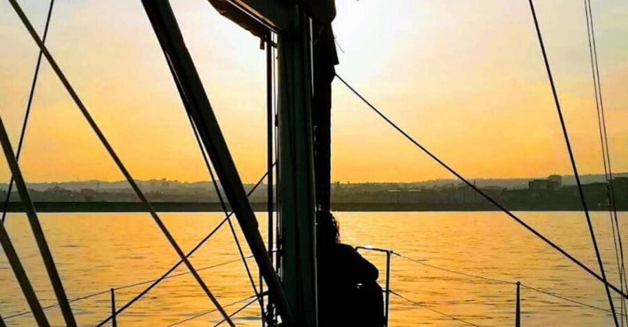 Catania: Guided Sunset Sailing Trip with Aperitif & Prosecco - Approaching the Caves of Ulysses: The Scenic Payoff Moment